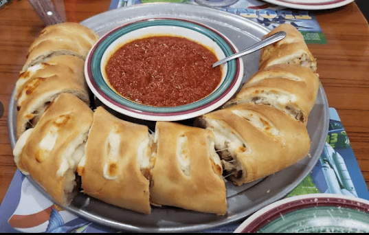 Authentic Italian pizza cooked fresh at Tomatoes Pizzeria in Lake Worth